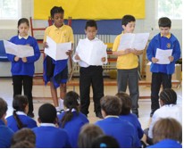 Photo of school children reading poetry